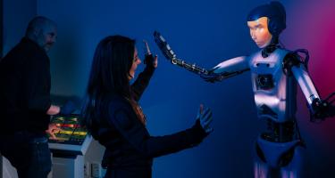 woman interacting with an anthropomorphized robot