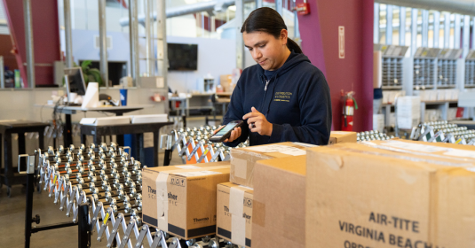 UC Davis Mail Services worker processing packages