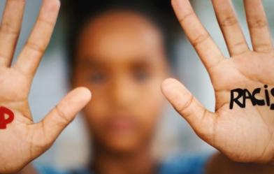 "Stop racism" message written on palms of hands