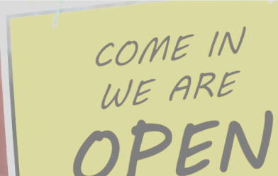 "We are open" sign in a small business window