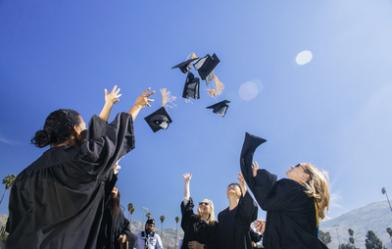 Graduating students tossing caps in the air