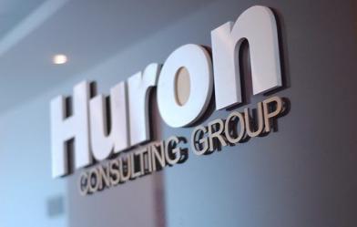 Huron Consulting Group logo sign on a wall