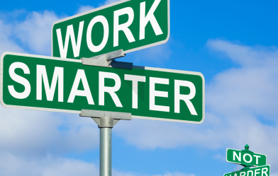 A set of perpendicular street signs that say "Work" and "Smarter."
