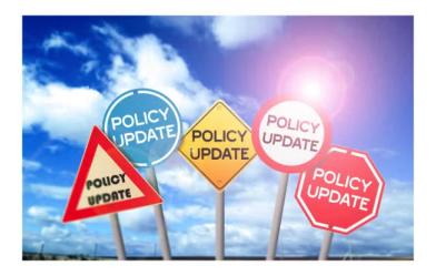 Stylized image of four signs all reading "Policy Update" 