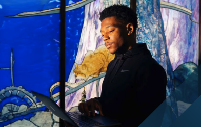 Man looking at a laptop screen with colorful background