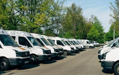 Photo of white vans in a parking lot