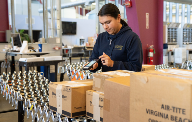UC Davis Mail Services worker processing packages
