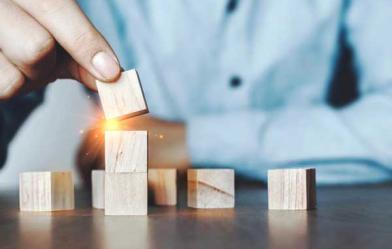 A man stacking wooden blocks