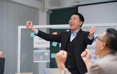 a business man raising his arms in triumph