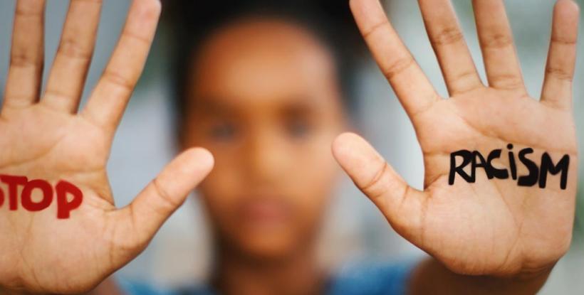 "Stop racism" message written on palms of hands