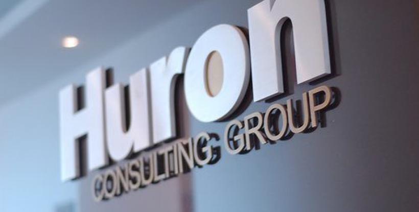 Huron Consulting Group logo sign on a wall
