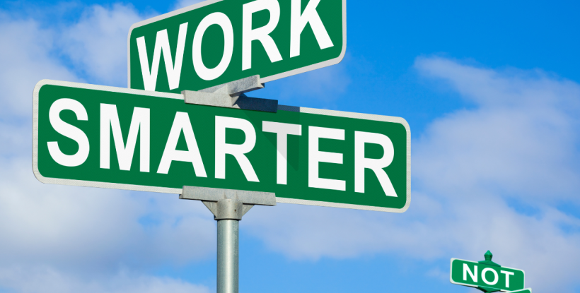 A set of perpendicular street signs that say "Work" and "Smarter."