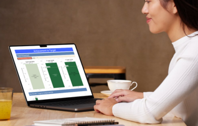 woman using a laptop to edit a dashboard