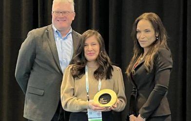 three people getting an award