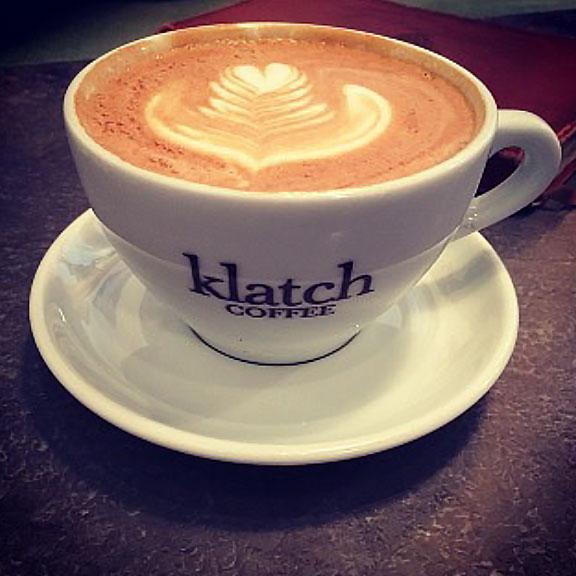 A cup of Klatch coffee on a saucer