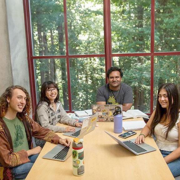 Interns analyzing campus spend data at a table together