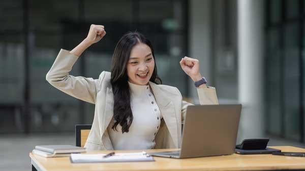 A happy woman using a laptop